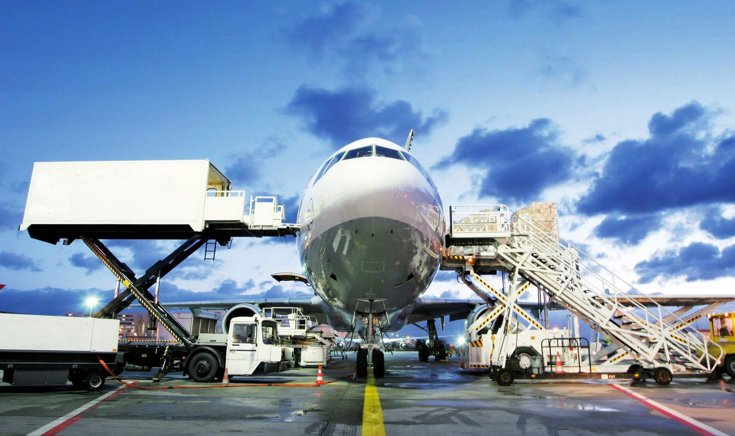 airplane on the airport, loading cargo to the airplane, trucks standby, providing door-to-door service to ship cargo with shorter transit time, better experience